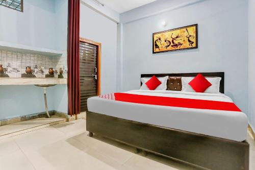 a bedroom with a large bed with red pillows at Flagship Rk Residency Near Iskcon Temple Noida in Noida