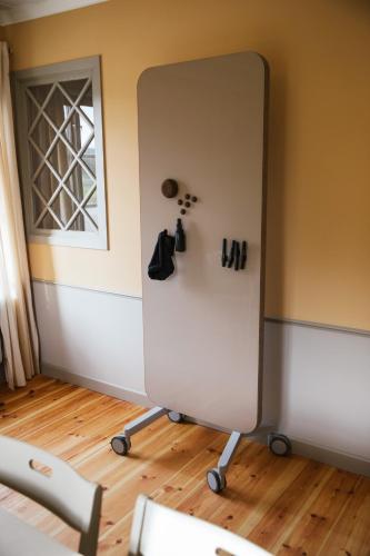 a mirror in the corner of a room at STF Undersvik Gårdshotell & Vandrarhem in Vallsta
