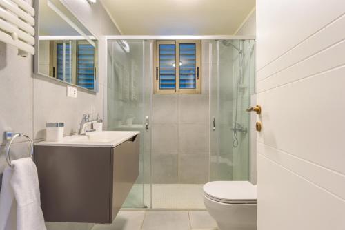 a bathroom with a shower and a sink and a toilet at 961 Station Apartments in Mar Mikhael in Beirut