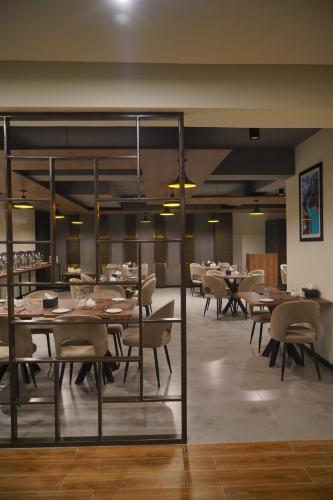 a dining room with wooden tables and chairs at Destination Hotel Gilgit in Gilgit