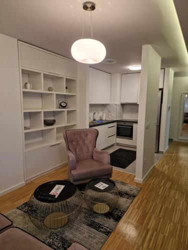 a living room with a chair and a table at Nika in Banja Luka