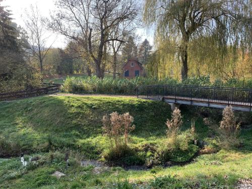 a bridge over a river in a park at Ferienwohnung Am Kurpark 