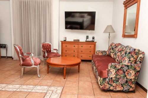 a living room with a couch and a table at Hotel Boutique Naura Centro in Oaxaca City