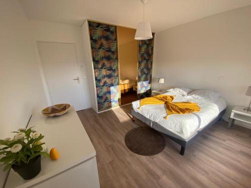 a bedroom with a bed with a yellow blanket on it at Résidence de Grasse in Grasse