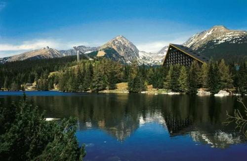 a view of a lake with mountains in the background at Apartment 416 with mountain view in Hotel Crocus, Strbske Pleso in Štrbské Pleso
