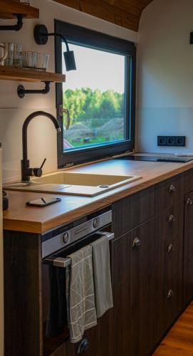 a kitchen with a sink and a window at VAGONBublava in Bublava
