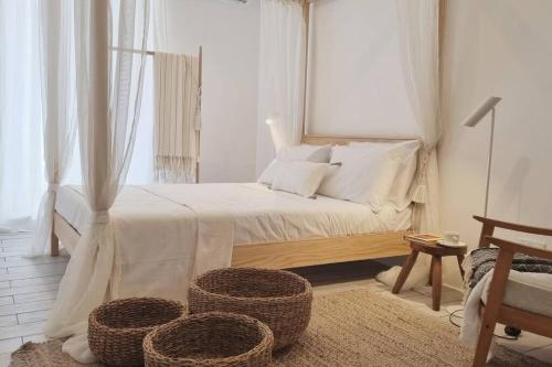 a bedroom with a bed with two baskets on the floor at Experience Nirvana in Msida