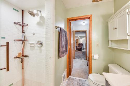 a bathroom with a toilet and a walk in shower at Convenient Racine Home 4 Mi to Lake Michigan! in Racine