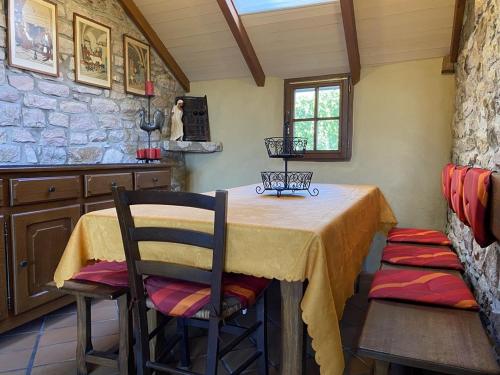 une salle à manger avec une table et deux chaises dans l'établissement 661 - Charmante maison en pierre sur les Hauteurs d'Erquy avec vue mer, à Erquy