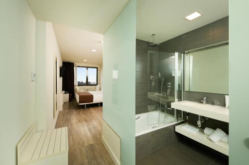 a bathroom with a shower and a sink and a toilet at 1881 Barcelona Gran Rosellon Hotel in Barcelona