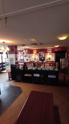 a fast food restaurant with a counter in a room at Hotel Joinville Hippodrome in Joinville-le-Pont