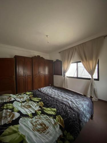 a bedroom with a bed and a window at Iyad apartment in Amman