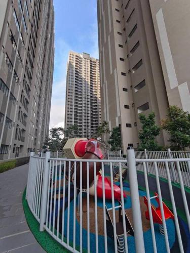 a white fence with a pool in the middle of a city at Awana Akasia Homestay in Nilai