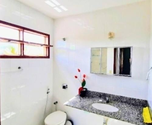 康塞桑達巴拉的住宿－Casa para Temporada e Carnaval em Conceição da Barra，一间带水槽、卫生间和镜子的浴室
