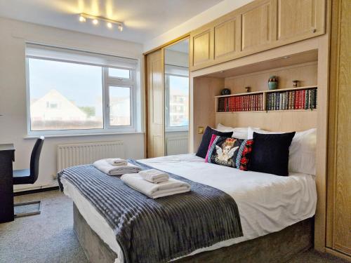 a bedroom with a large bed with towels on it at Sea Scene's , Hayling Island in South Hayling