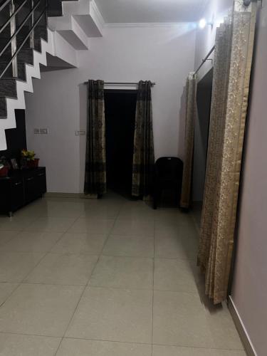 a hallway with a staircase and a tiled floor at Shiv mahima nivas in Bareilly