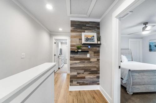 a bedroom with a reclaimed wood accent wall at Wisteria Escape - East Hill in Pensacola
