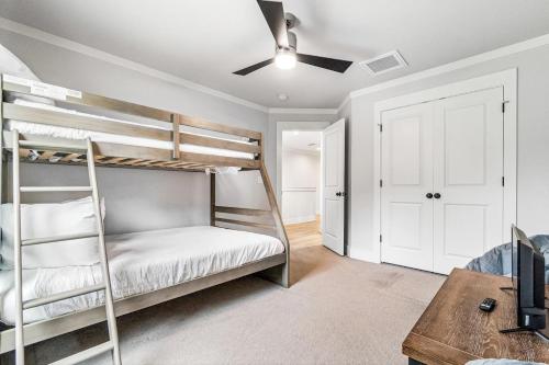 a bedroom with two bunk beds and a table at Wisteria Escape - East Hill in Pensacola