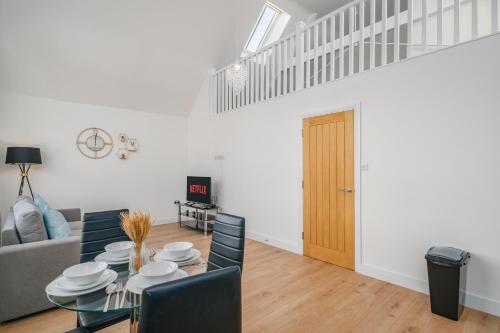 a dining room and living room with a table and chairs at Contractors I Working professionals I Relocators - Near Train Station and Airport in Luton