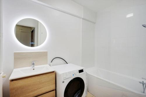 une machine à laver dans une salle de bain avec un lavabo dans l'établissement Appartement refait à neuf - Paris, à Paris