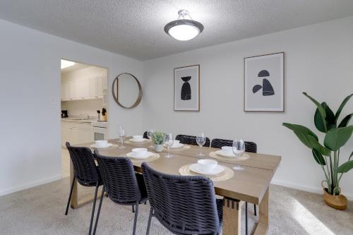 a dining room with a wooden table and chairs at Airport Proximity Condo at Crystal City in Arlington