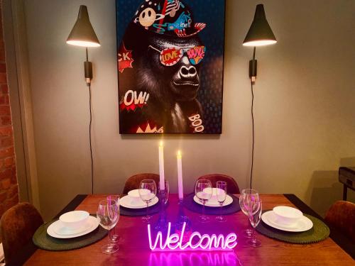 a dining room table with a welcome sign on it at The Fifth Quarters, Grade II Listed Apartment, The Lace Market, NG1, City Centre, Nottingham, Sleeps 4 in Nottingham