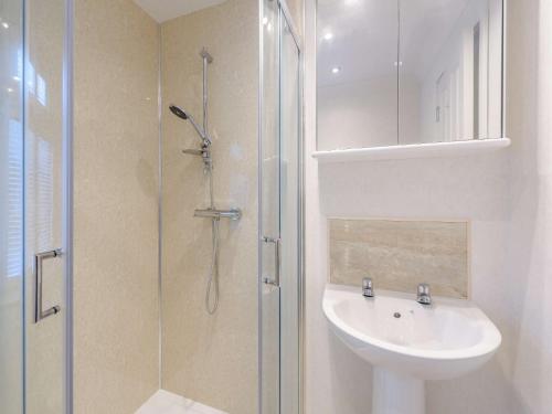 a white bathroom with a sink and a shower at 2 Bed in Okehampton 85432 in Okehampton
