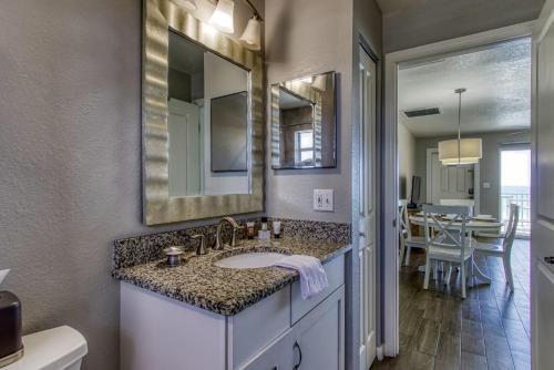 a bathroom with a sink and a mirror at The New Hotel Collection Beachfront in Clearwater Beach