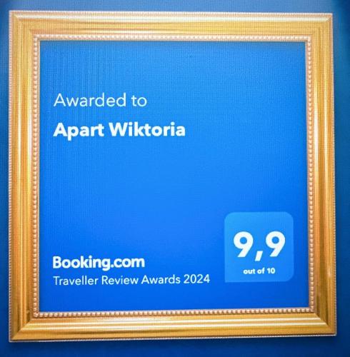 a picture of a picture frame with a sign that reads awarded to aprant wil at Apart Wiktoria in Warsaw
