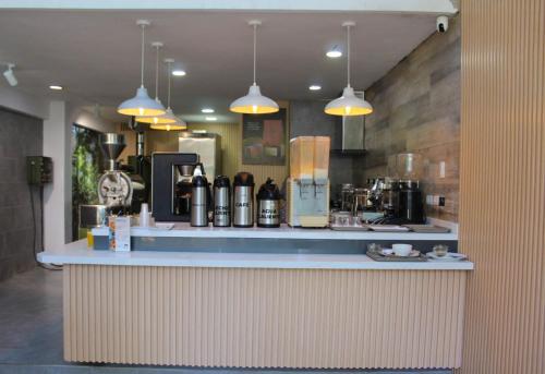 a kitchen with a counter with a coffee maker at Hotel Genova Prado in Barranquilla