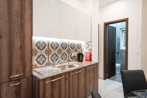 a bathroom with a sink and a counter top at Aloha - Village Apartment 2 BR in Mellieha in Mellieħa