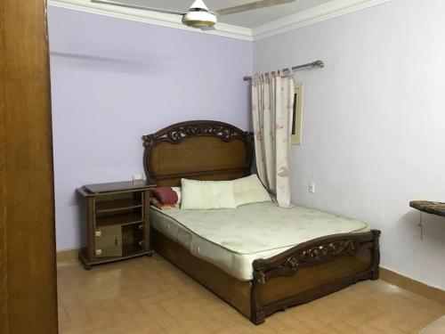a bedroom with a bed and a night stand at Lovely 3-bedroom rental unit.cozy and friendly in Cairo