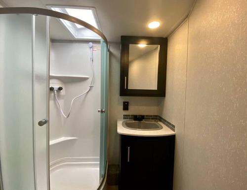 a small bathroom with a sink and a shower at Paschal Winery - Water's Edge in Talent