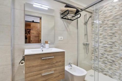 a bathroom with a sink and a glass shower at Margherita House Tenerife, Wonderful Ocean View in Palm-mar