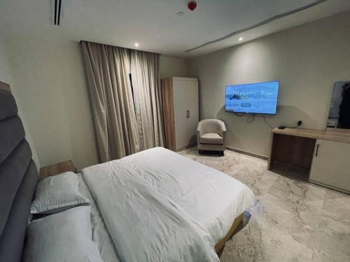 a hospital room with a bed and a tv at Luxurious, self-enter apartment in Jeddah