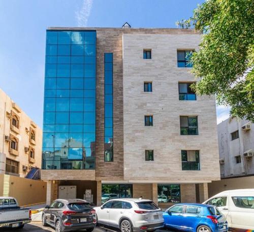 a building with cars parked in front of it at Luxurious, self-enter apartment in Jeddah