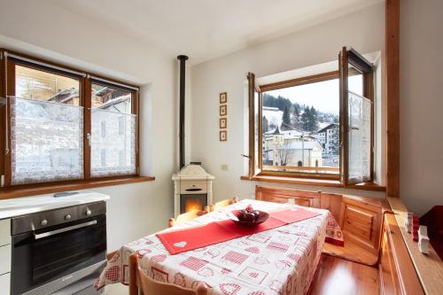 a kitchen with a table with a red napkin on it at Dolomiti Openspace Free Parking in San Nicolò di Comelico