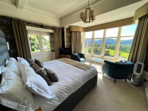 a bedroom with a bed with a teddy bear on it at Ravenstone Manor in Keswick