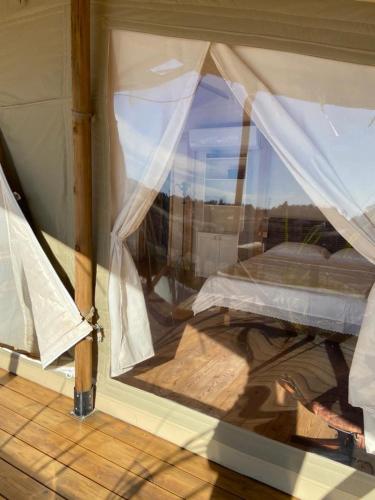 a reflection of a bed in a window at למדבר- חווית גלמפינג במדבר in Arad