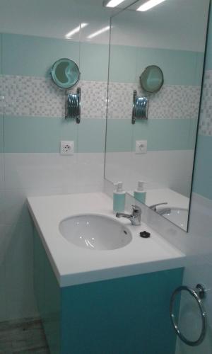 a bathroom with a sink and a mirror at Vila Mar in Vila Franca do Campo
