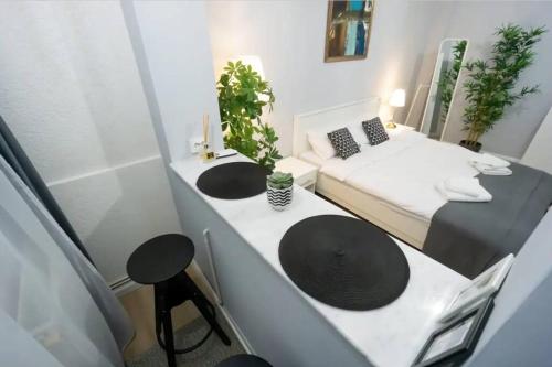 a small room with two sinks and a bed at Ultra Central Fun in Bucharest