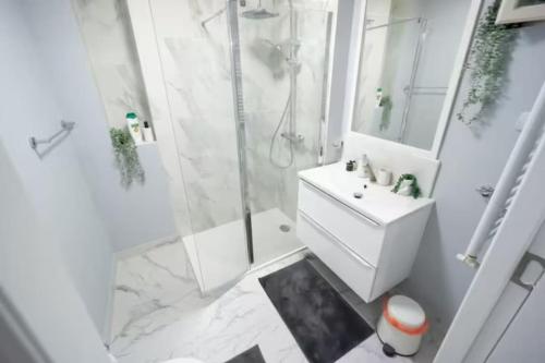 a white bathroom with a shower and a sink at Ultra Central Fun in Bucharest