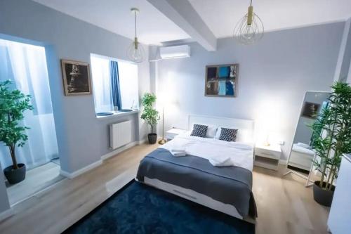 a large bedroom with a large bed and a blue rug at Ultra Central Fun in Bucharest