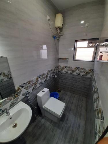 a bathroom with a sink and a toilet at Hotel RSA Residency in Pernem