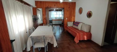 a living room with a table and a couch at Casa, quincho, garage y parque.apta 10 personas in Mar del Plata