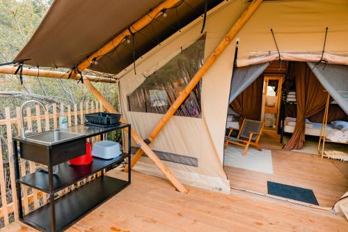 a view of a tent with a kitchen and a balcony at Huttopia Paradise Springs in Valyermo