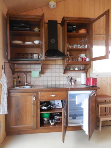 eine Küche mit Holzschränken und einer Arbeitsplatte in der Unterkunft Studio on Monte Generoso in Castel San Pietro