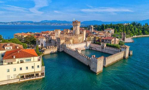 an aerial view of a town on the water at Villa Laura in Toscolano Maderno