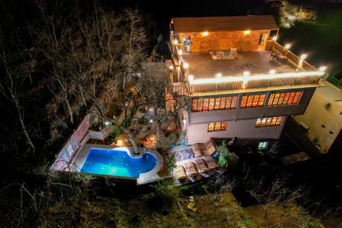 an aerial view of a house at night with a swimming pool at Riad Atlas Bangalo in Imlil