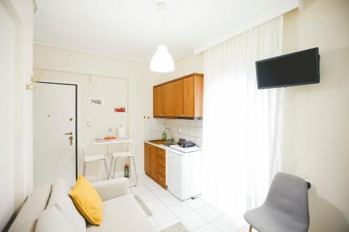 a small kitchen with a sink and a counter at Tiny Studio in Larisa